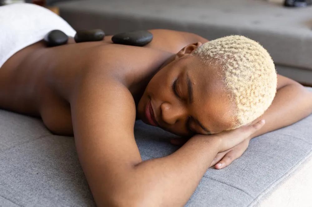 Happy African American Woman Lying With Hot Stones